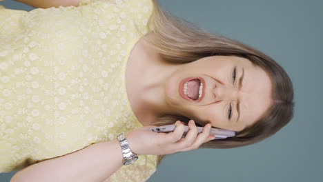Vertical-video-of-Angry-woman-talking-on-the-phone.